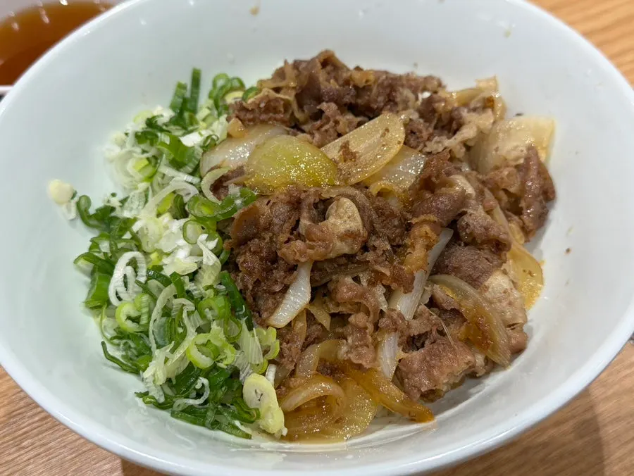 A spoonful of curry topped with croquette