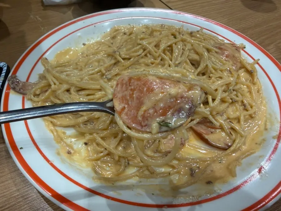 Thick cream sauce coating the pasta noodles