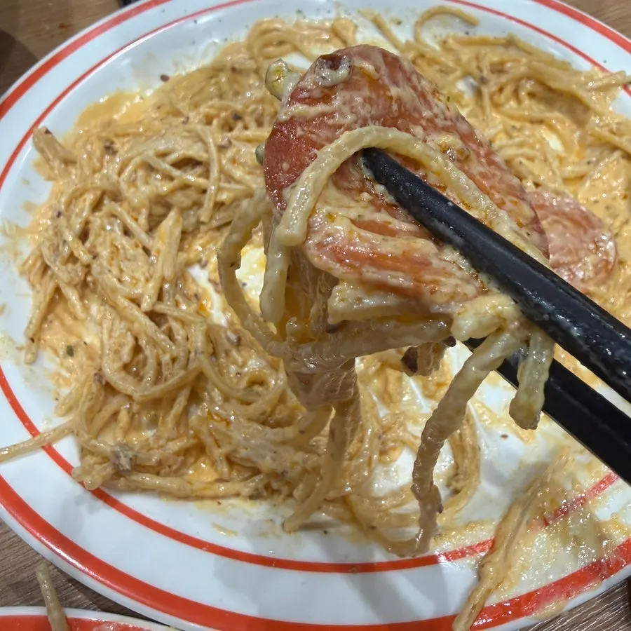 Pepperoni cream pasta twirled on a fork