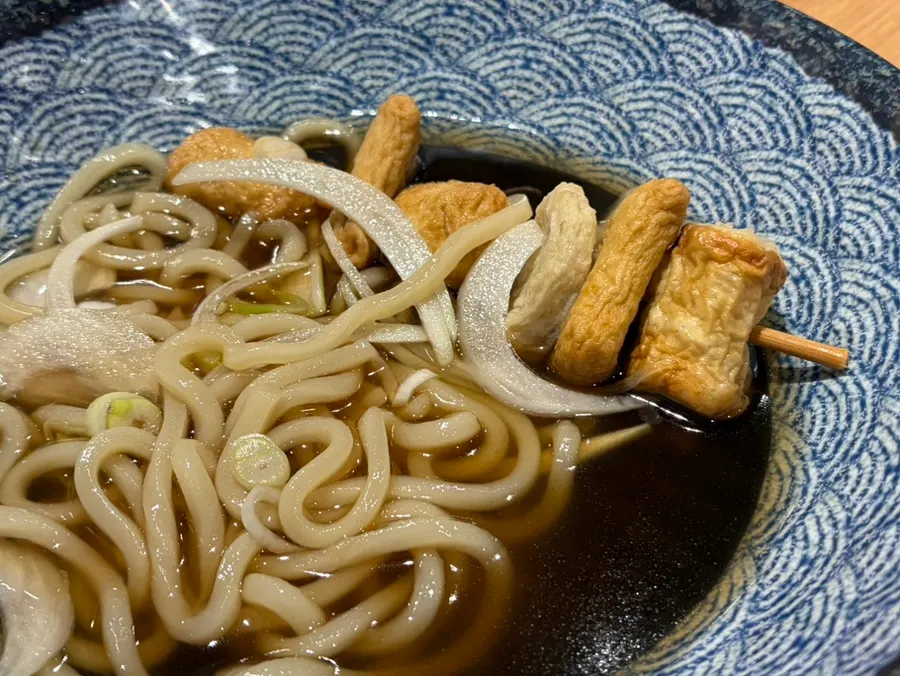 Two whole fish cake skewers in the udon