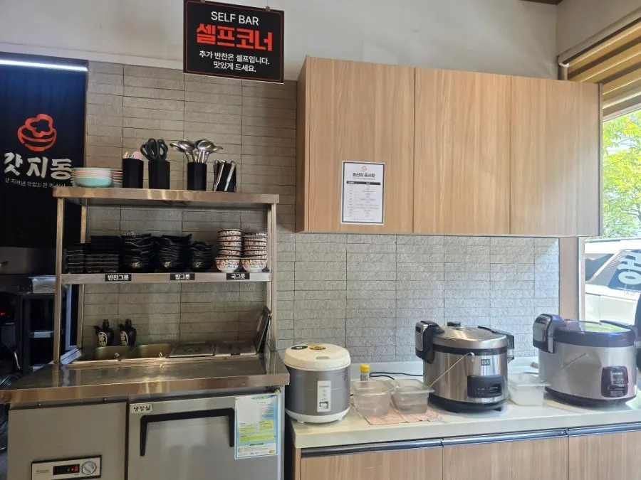 Self-serve corner with tableware, rice, soup and broth