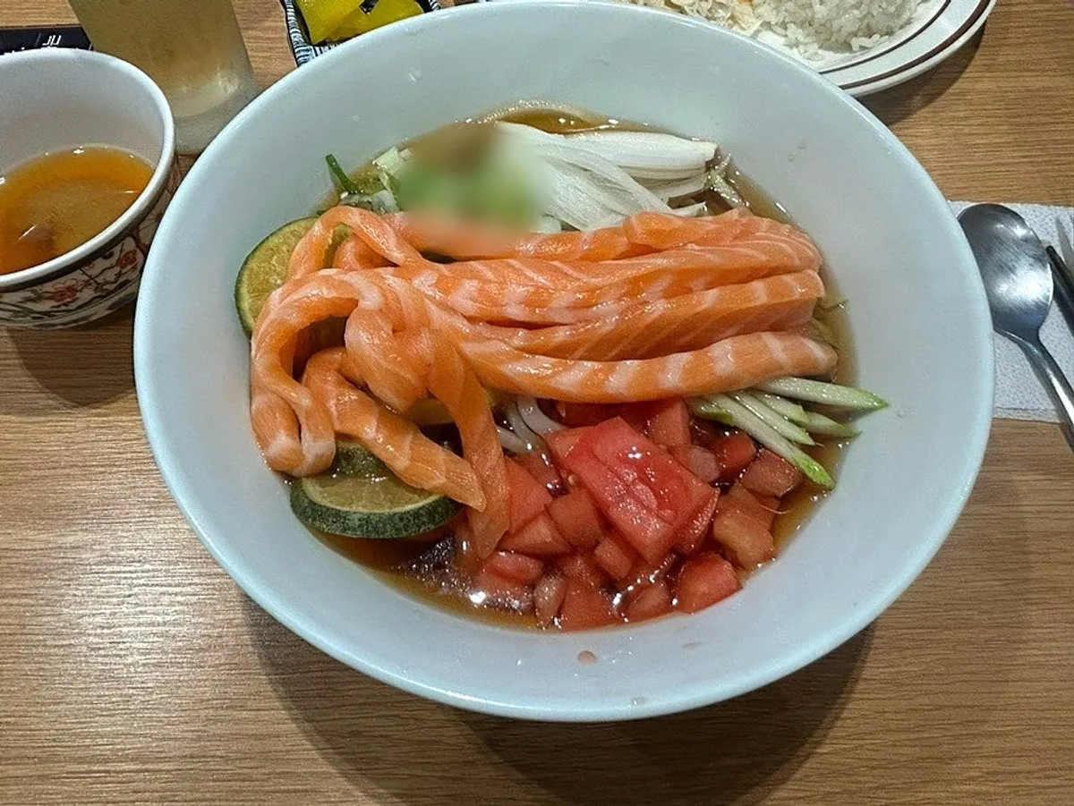 Tomato citrus salmon udon topped with plump salmon