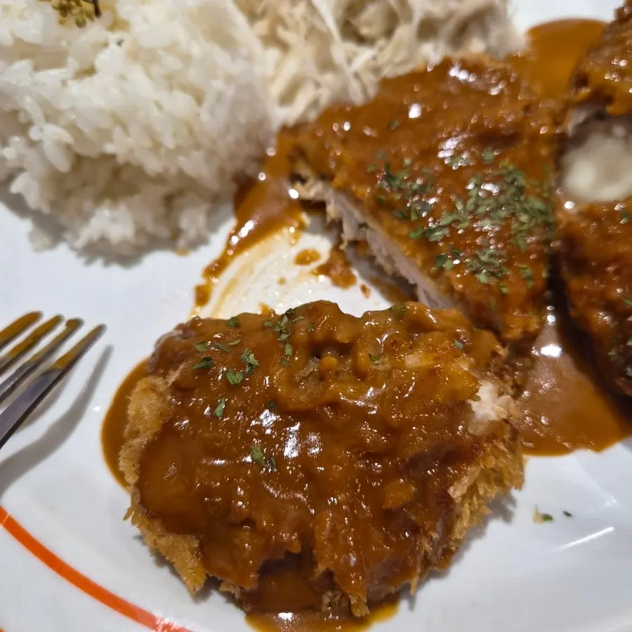 Loin cutlet piece generously coated with sauce