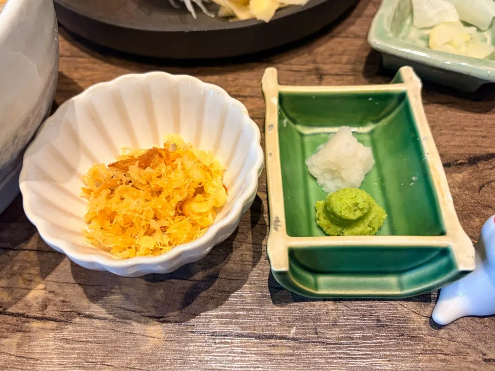 Cold udon topped with grated radish, wasabi, and tenkasu
