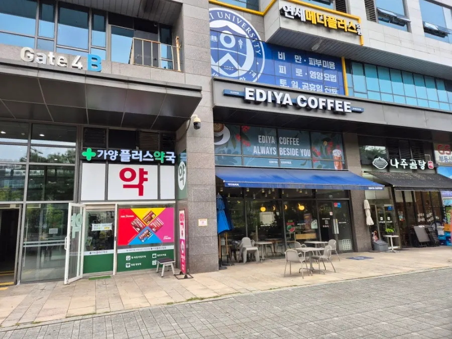 Restaurant exterior with a black awning and floor-to-ceiling windows