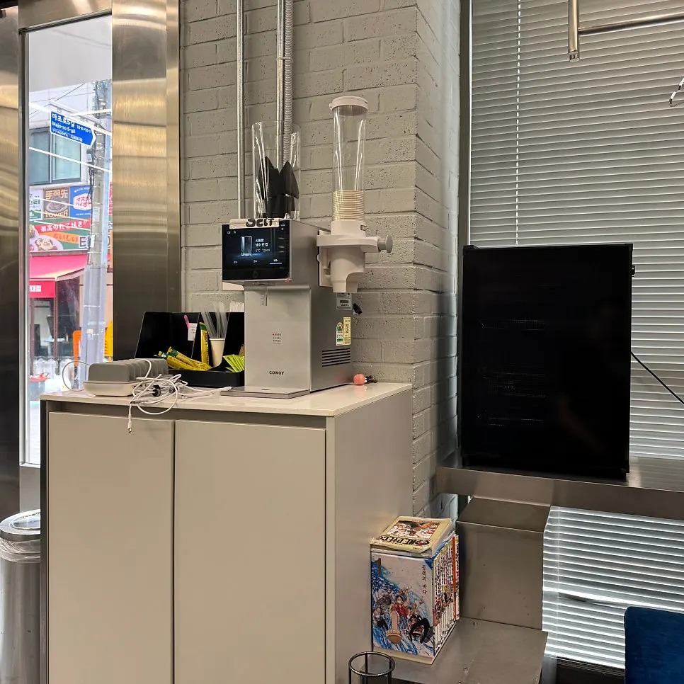 Drink bar with coffee machine, water purifier, and comic books