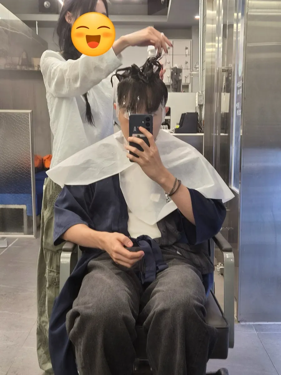 Down perm being applied to the side hair