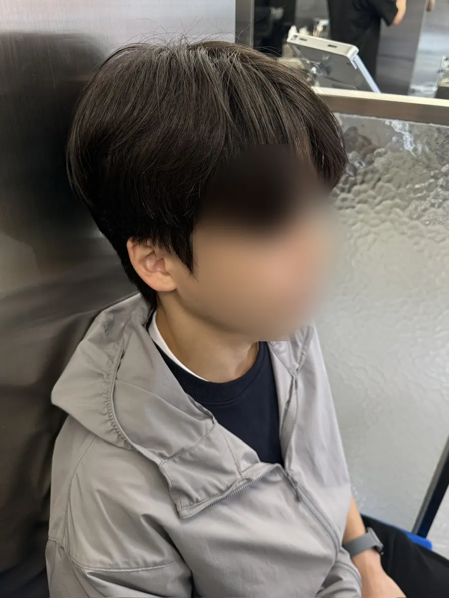 Man's hair with an overgrown fringe before the service