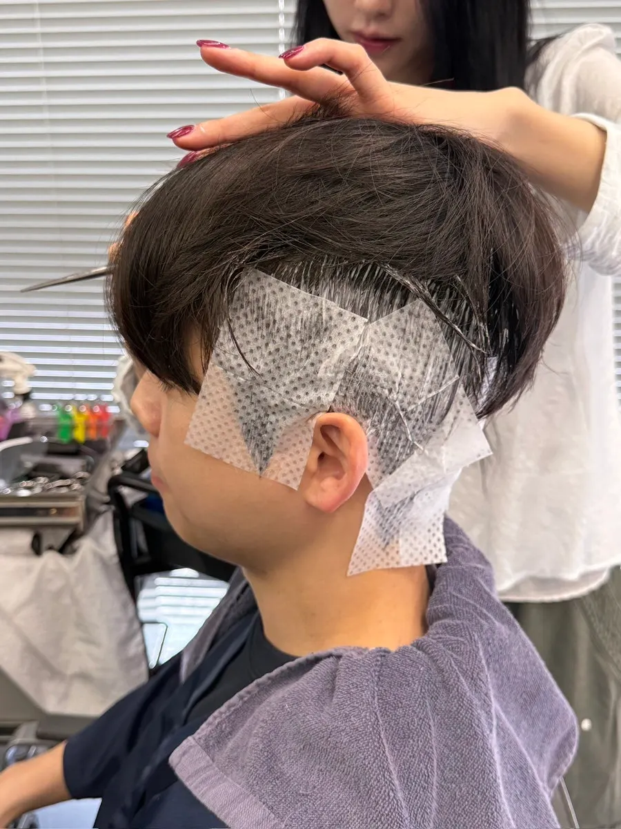 Down perm being applied for the see-through dandy cut