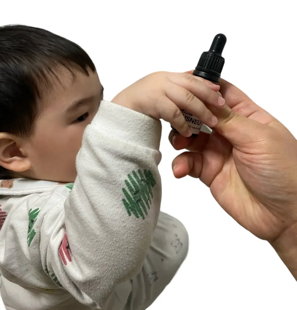 A child gesturing with fascination at the dropper