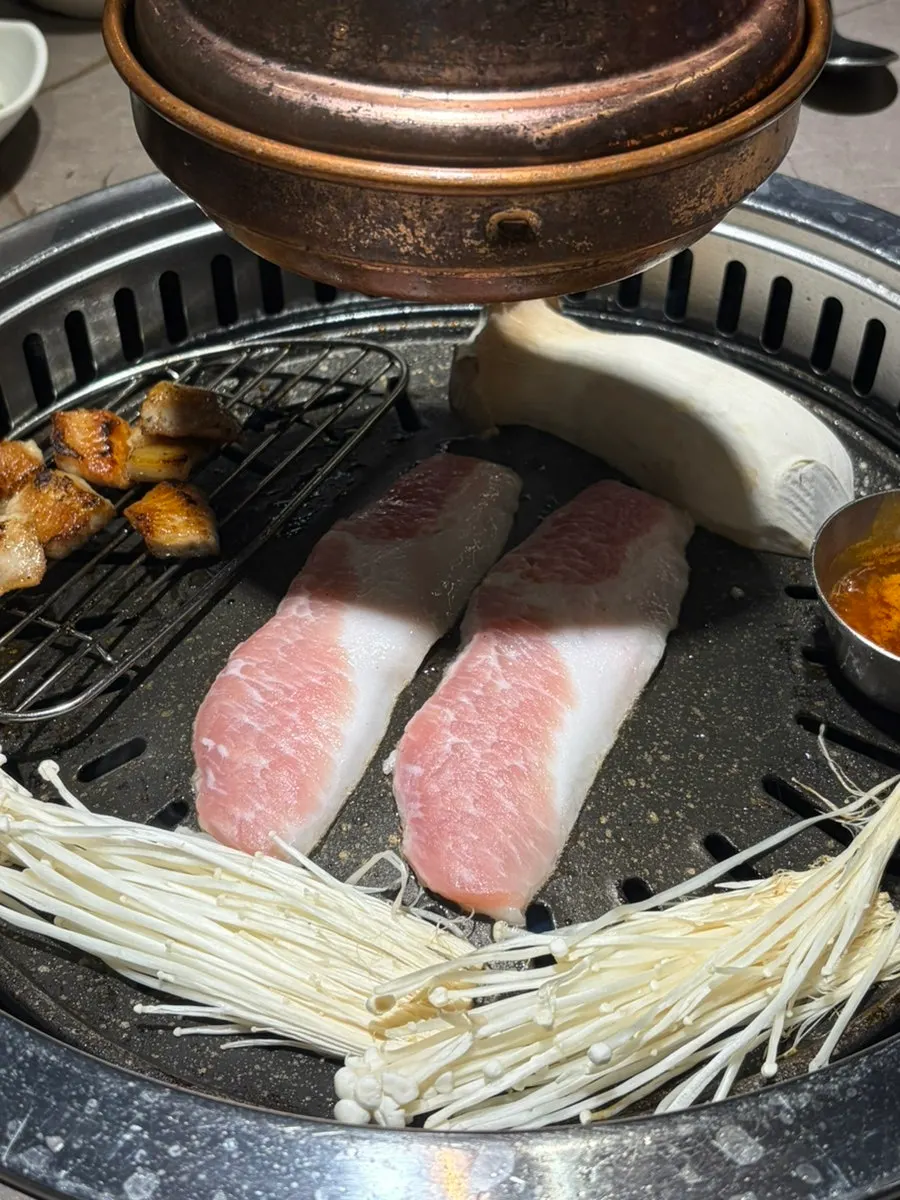 Pork jowl and gabrisal cooking on the grill