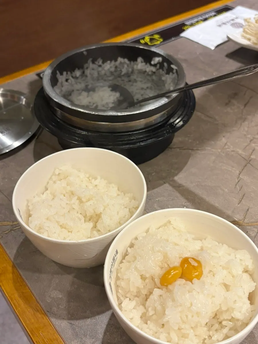 A spoonful of cauldron rice topped with a piece of meat