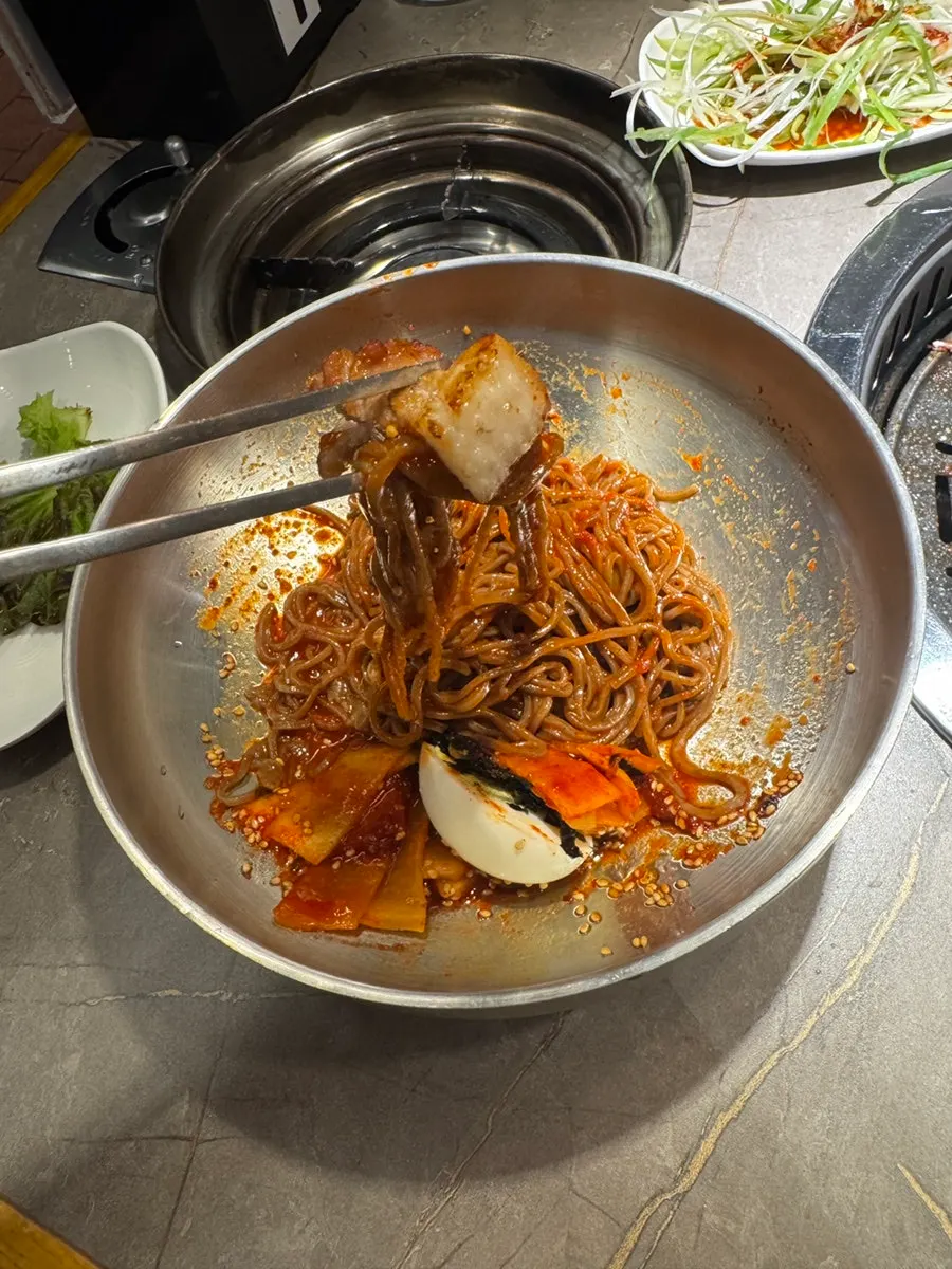 Table set with pork belly and bibim mak-guksu together