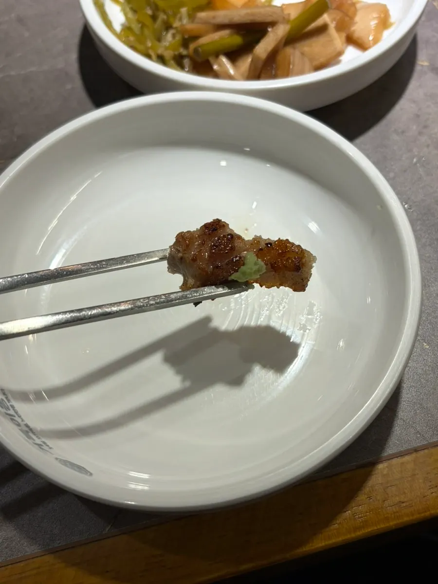 Grilled white kimchi with a piece of pork belly