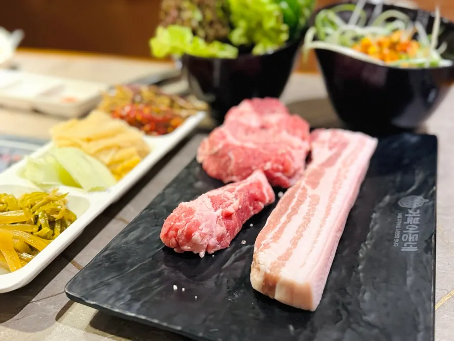 Dining table with aged pork belly and pork neck