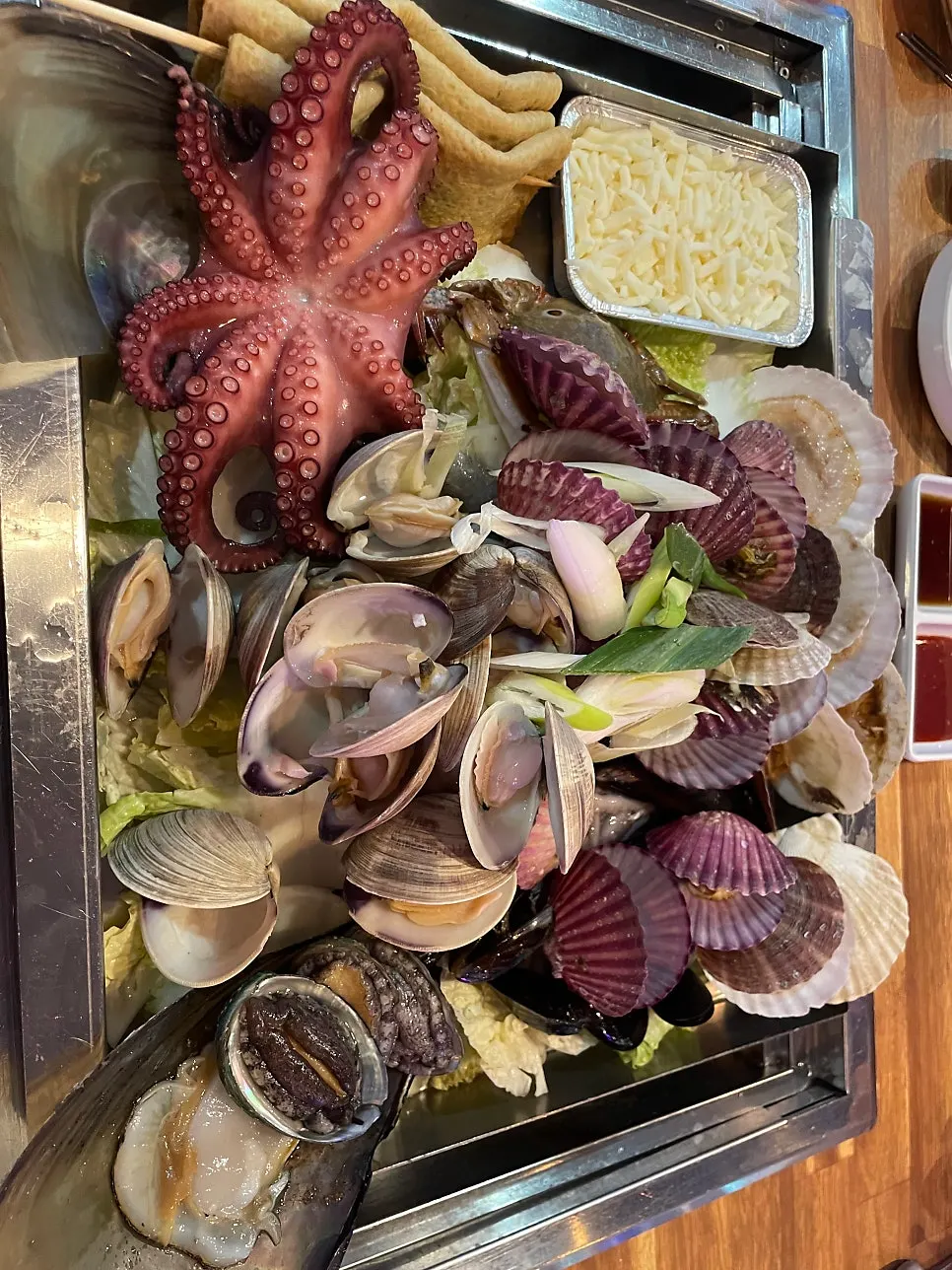 The generous 3-person steamed clams in broth, fully plated