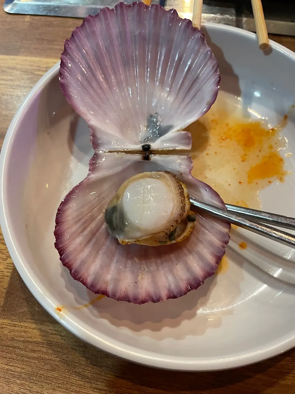 Seafood being fished out of the steamed clam pot