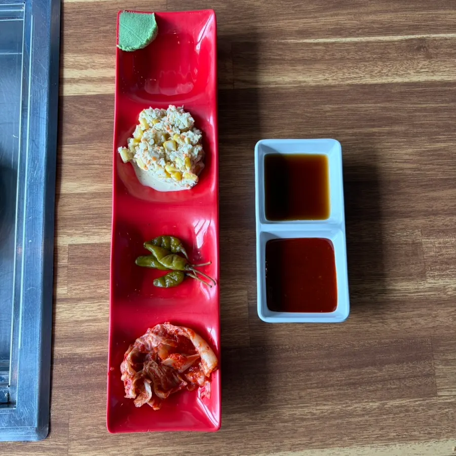 Basic side dishes: napa cabbage kimchi, pickled hot peppers, corn salad