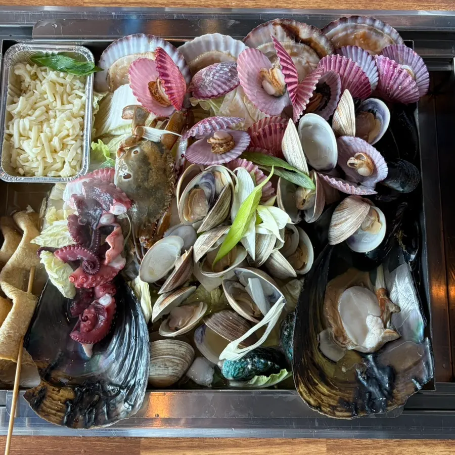 A full spread of steamed clams with added beef
