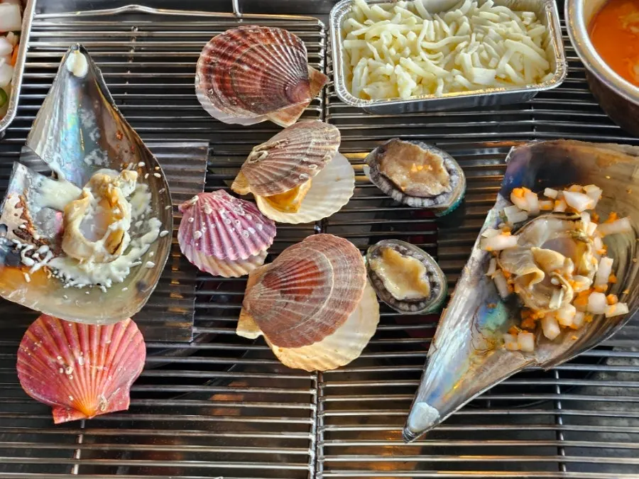Clams and shrimp cooking on the grill