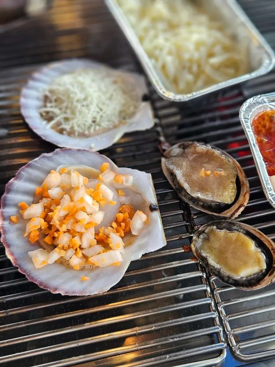 Close-up of fully cooked abalone and scallops