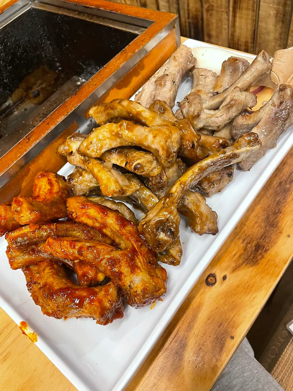 Pre-cooked jjokgalbi placed on the charcoal grill