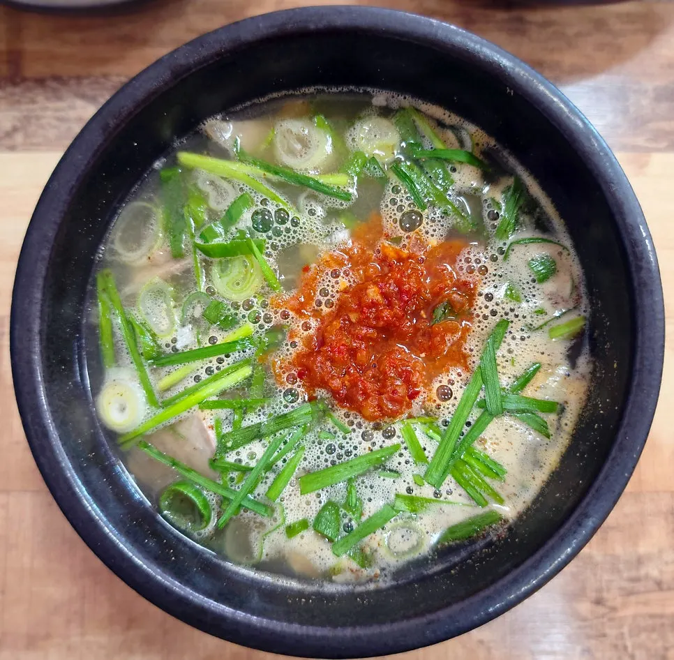 Pork gukbap in an earthenware bowl