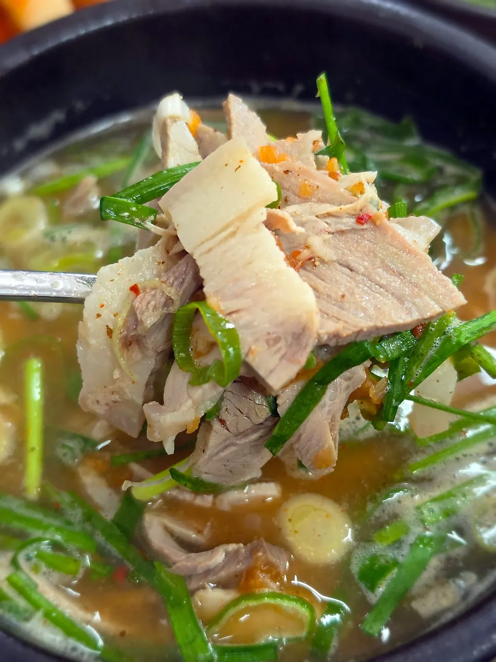 Close-up of pork gukbap broth and ingredients