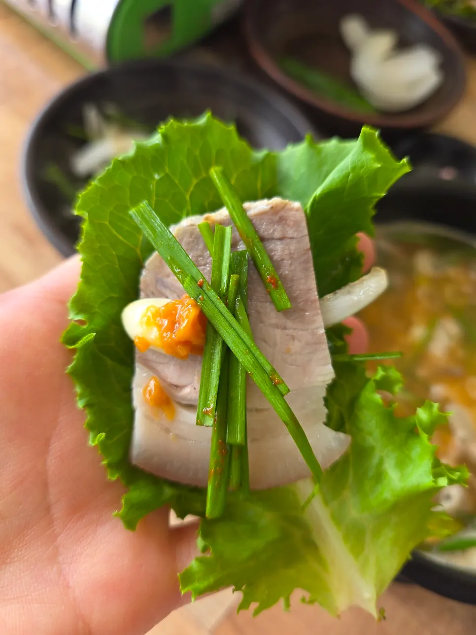 Wrapping suyuk in a lettuce leaf
