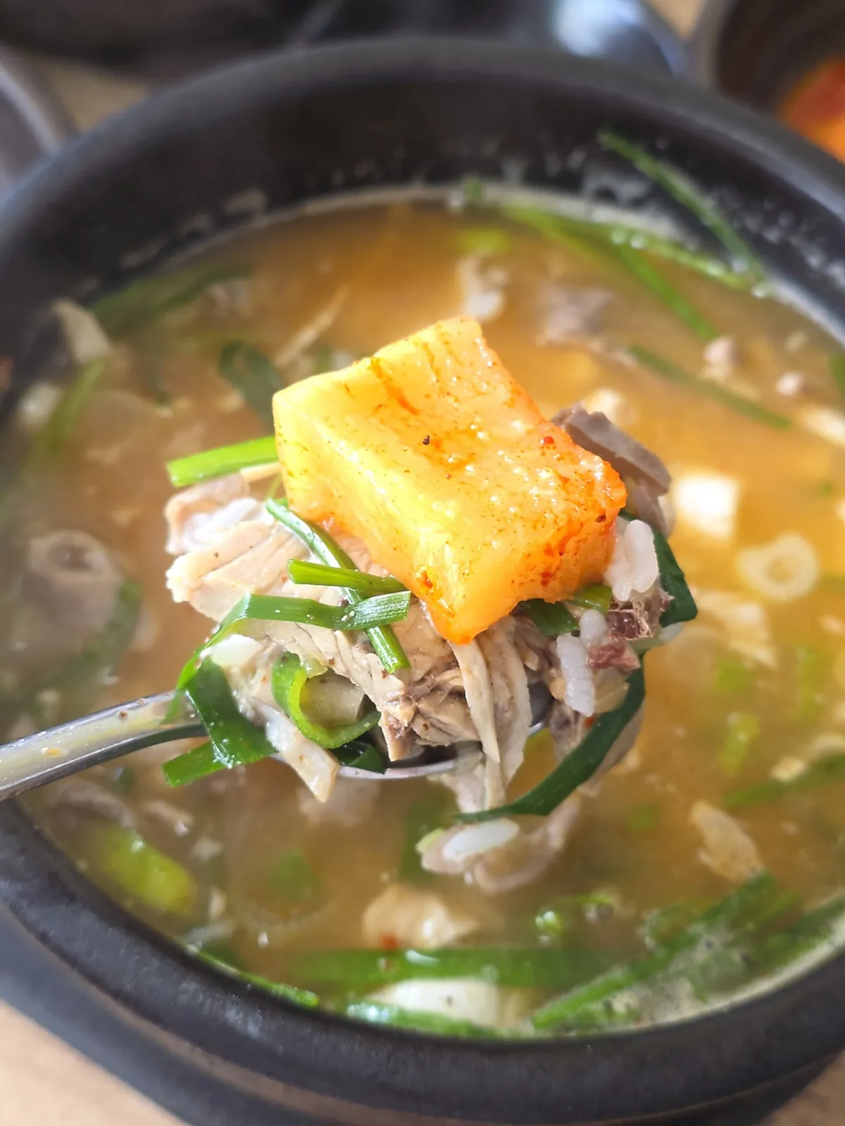 Mixed gukbap topped with seasoning sauce at Bongga Gukbap