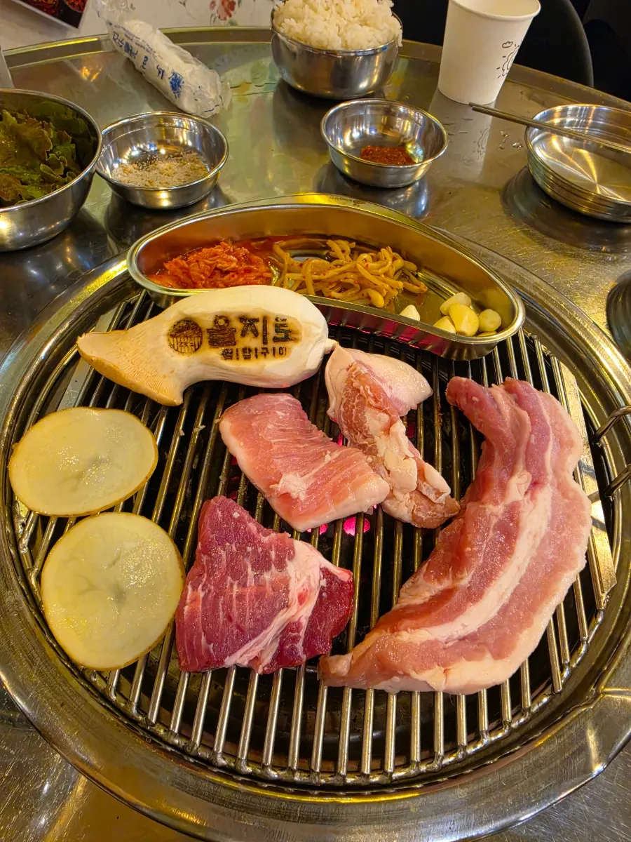 Pork and vegetables placed over charcoal briquettes
