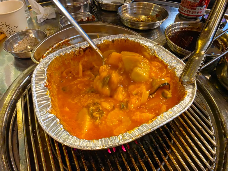 Grilled scallops stirred as they cook