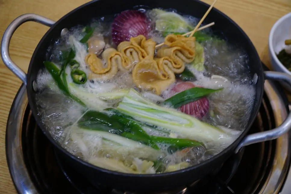 Enjoying the refreshing broth of the clam soup