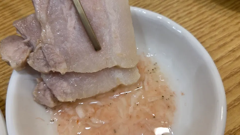 Clam soup and bossam served together on the table