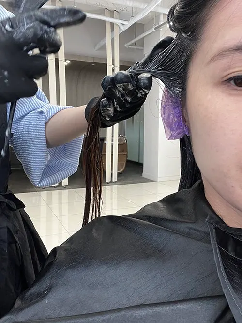 Applying dye after the scalp protector was sprayed on