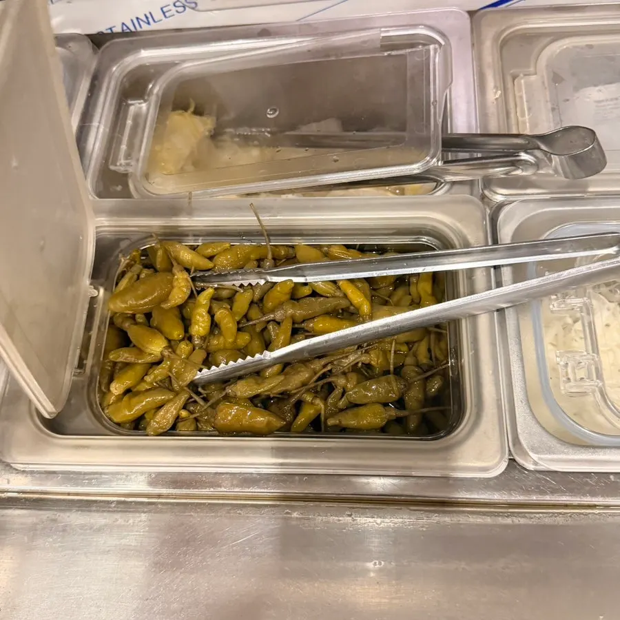 Pickled cucumber and pepper side dishes at the self-serve bar