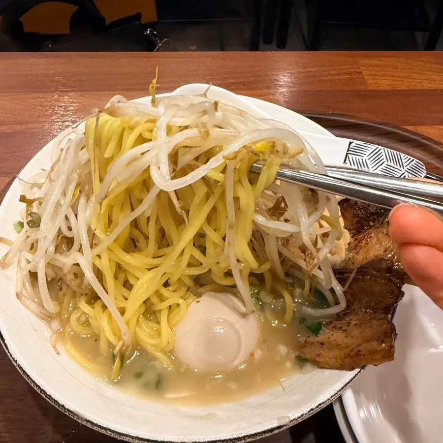 Ramen noodles lifted with broth