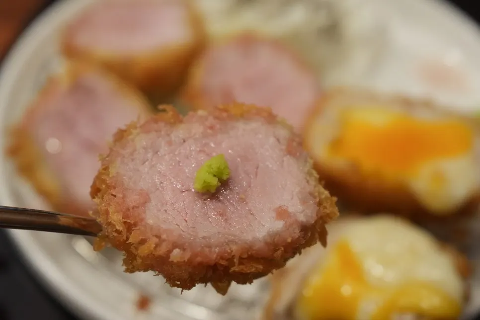 Cross-section of a thick tenderloin katsu showing its juices