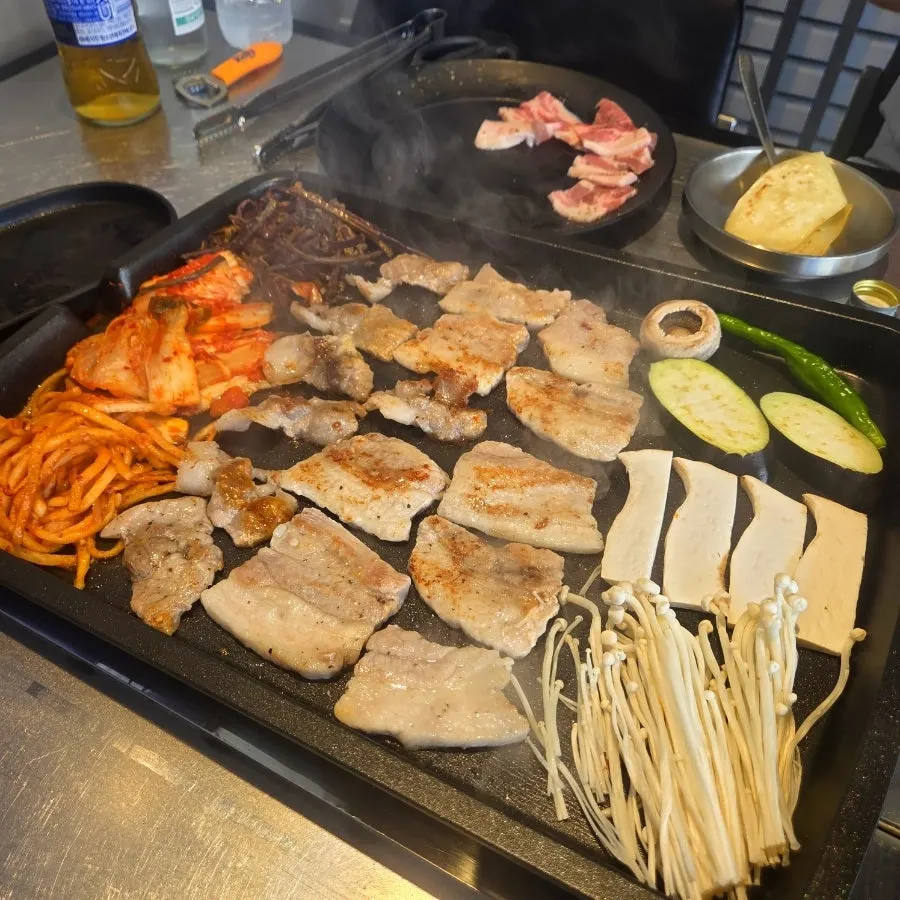 Taedon's grill plate topped with assorted mushrooms as well