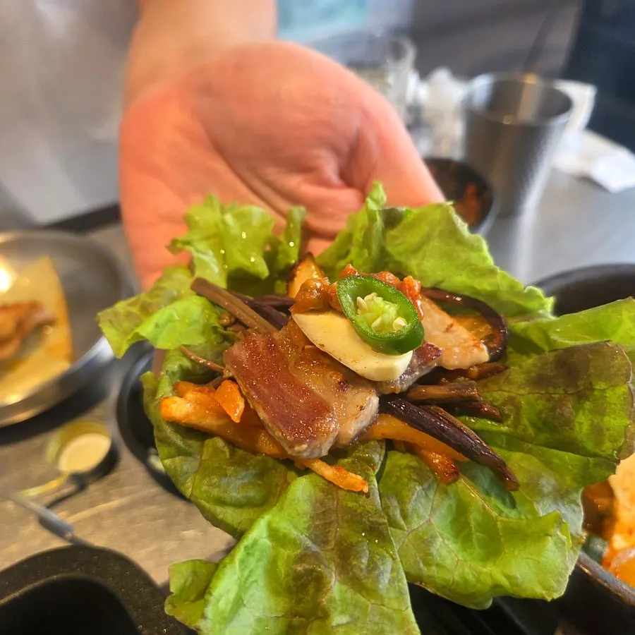 A wrap of bibim jjolmyeon topped with kkodeulsal