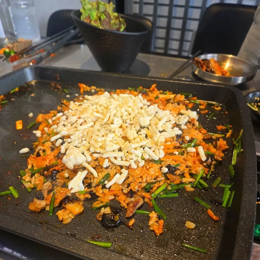 The finished kimchi fried rice topped with extra cheese