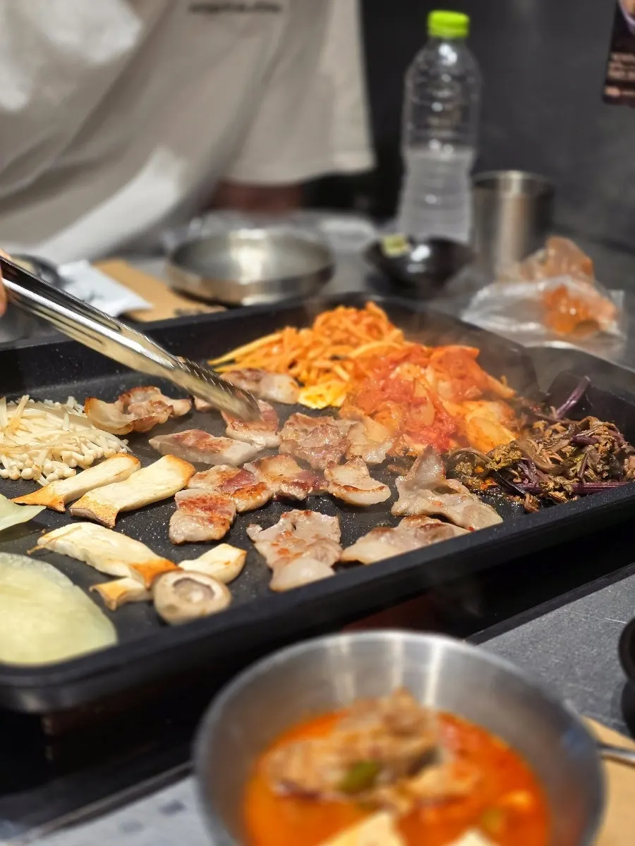 Grilled meat topped with kunefe