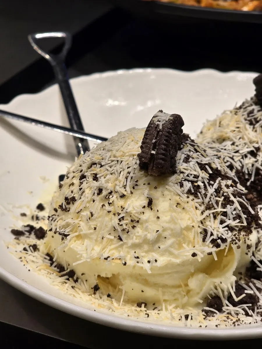 Ice cream dessert topped with kunefe and Oreo cookies