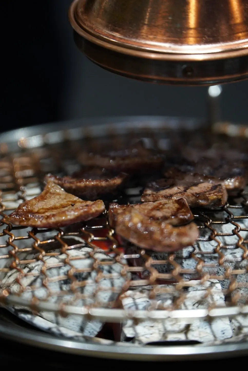 A staff member grilling hanwoo for the table
