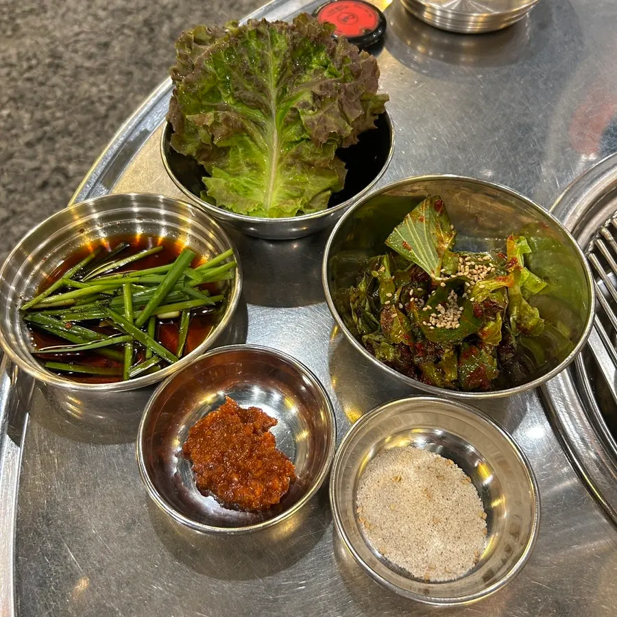 연탄 불판에 올린 김치와 콩나물, 마늘