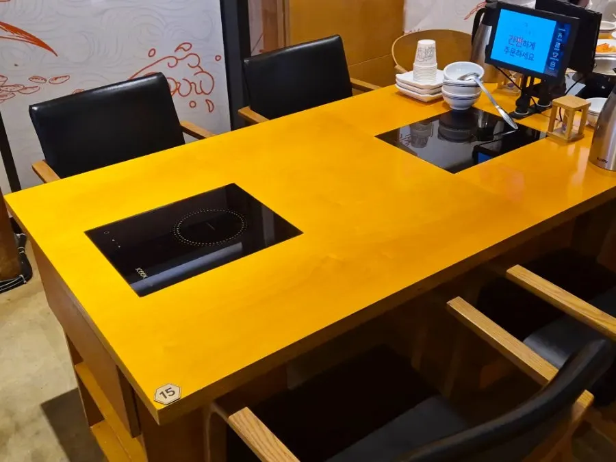 Wood-toned dining hall seating at Geumdeungeo Main Branch