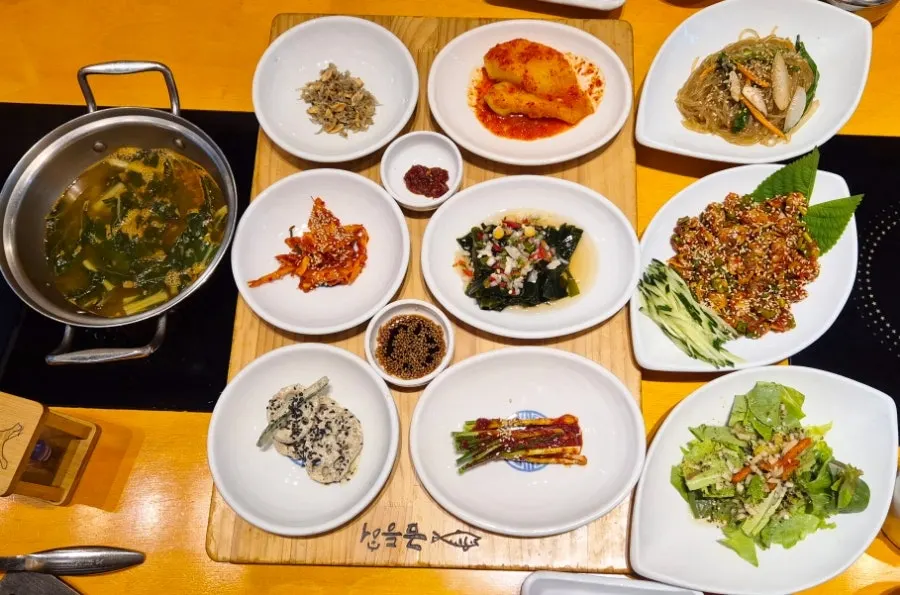 Table full of side dishes with the wood-fired mackerel spread