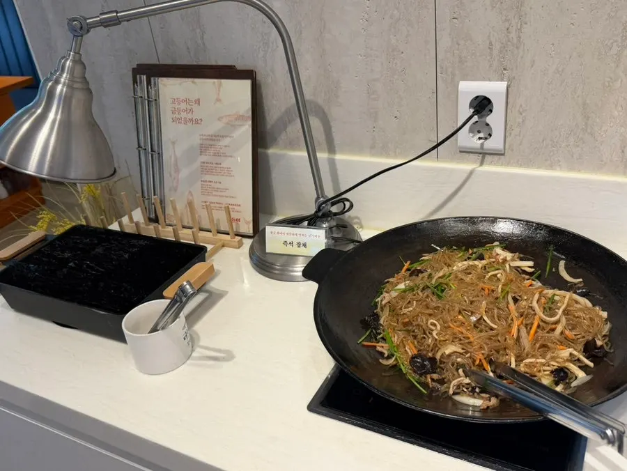 Japchae kept warm at the self-serve bar