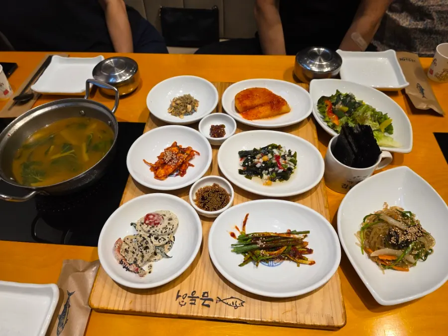 Hanjeongsik-style banchan spread on a wooden table