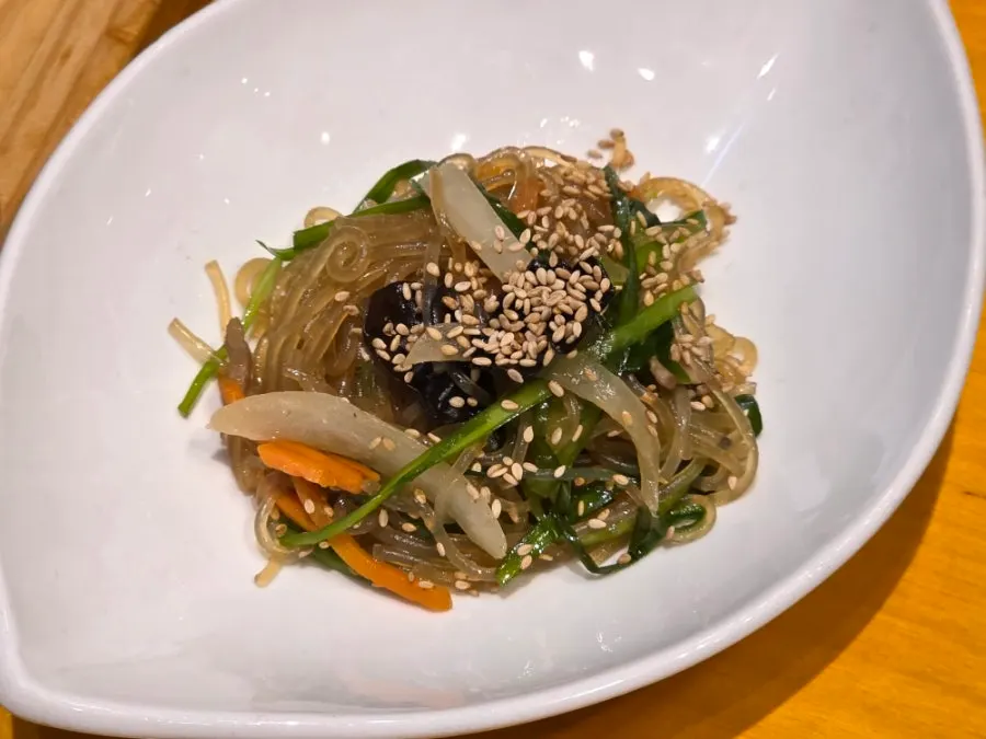 Salad, japchae, and stir-fried anchovy banchan
